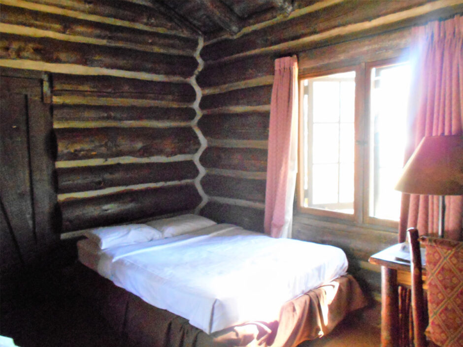Bed in log cabin
